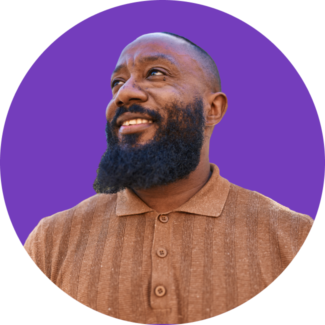 Man grinning and looking up to the left